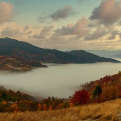 Ukraine. A magical autumn sunrise, with mist creeping over valleys, over mountain formations far from civilization. Synevyr pass located in the Carpathian mountains.